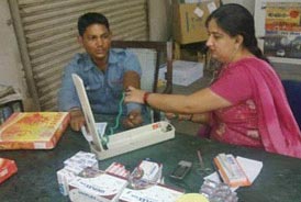 Blood pressure checks during the free health checkup for drivers by Tata Motors